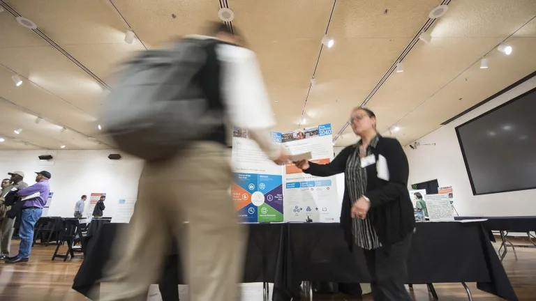 Two people shaking hands at an expo