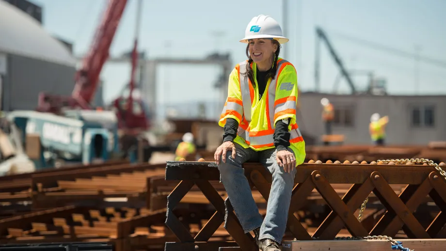 construction worker sitting on steel beams