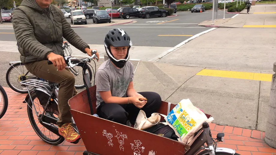 A dad shows off his creative child transport system at the North Berkeley BART Energizer Station.