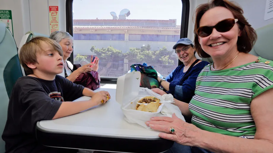 family sitting at table inside SMART train