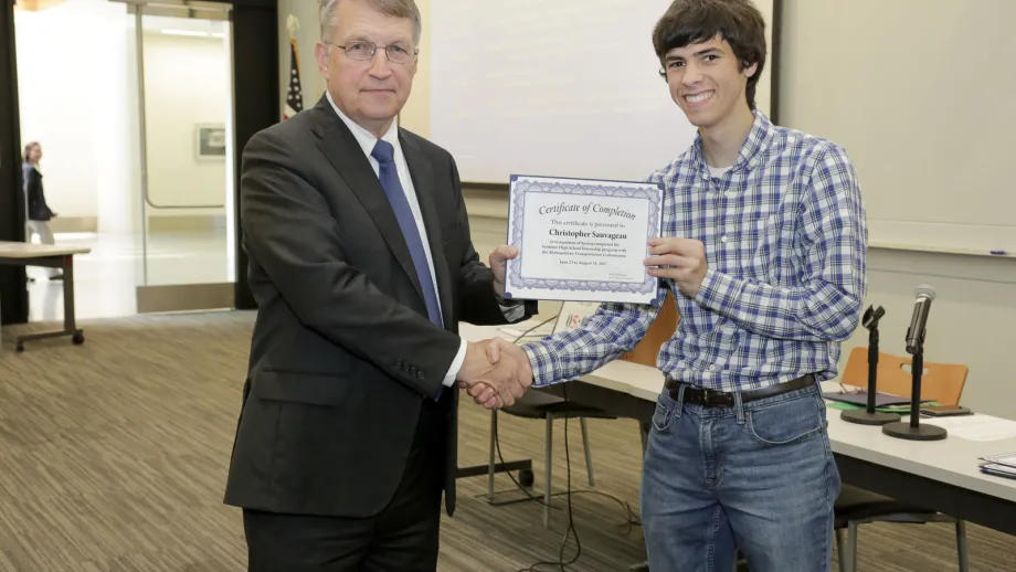 young adult being presented with an award