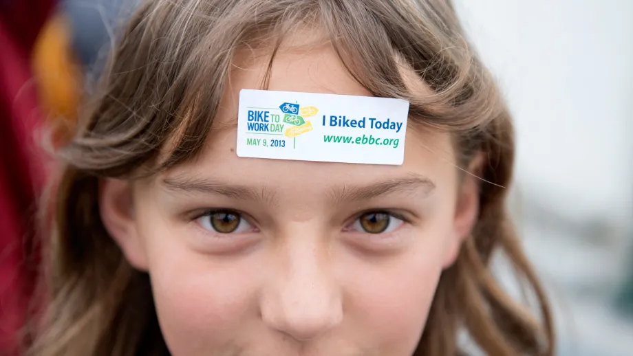 A young girl proudly displays the Bike to Work Day participation sticker at the site of the of a new bike path inaugurated today in Berkeley. 