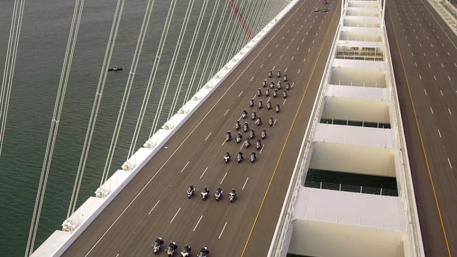 Several dozen California Highway Patrol officers, riding solo on motorcycles, led the way across the new span.
